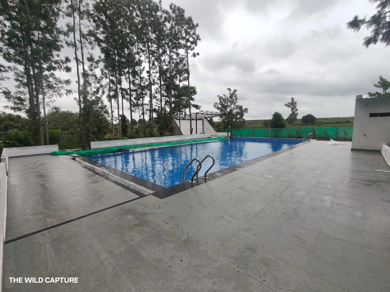 The swimming pool and its wide stone deck