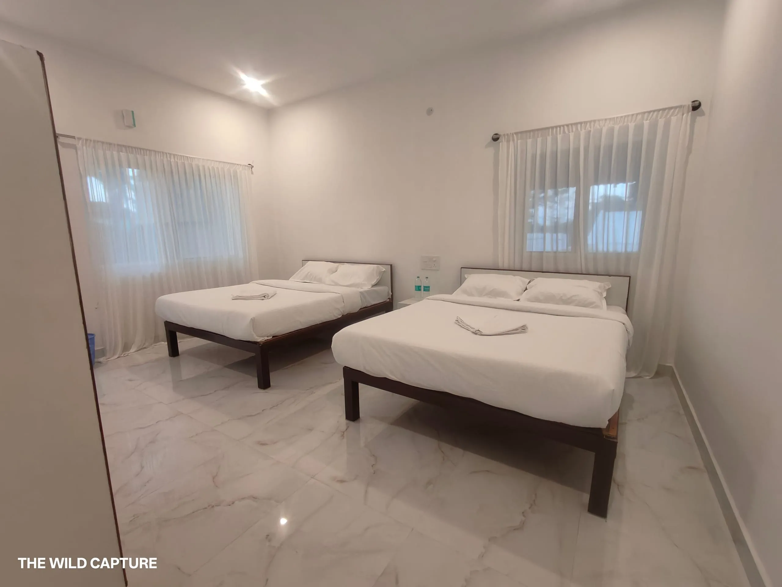 Guest room with daylight through sheer curtains
